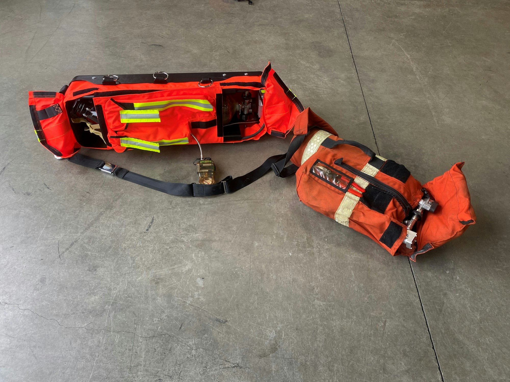 Old and new bright orange bags containing life saving fire equipment