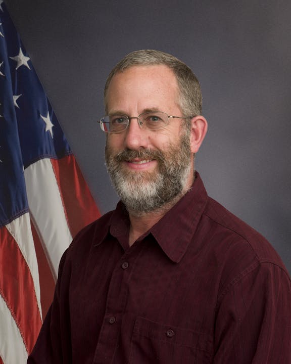 May contain: person, human, flag, symbol, and face