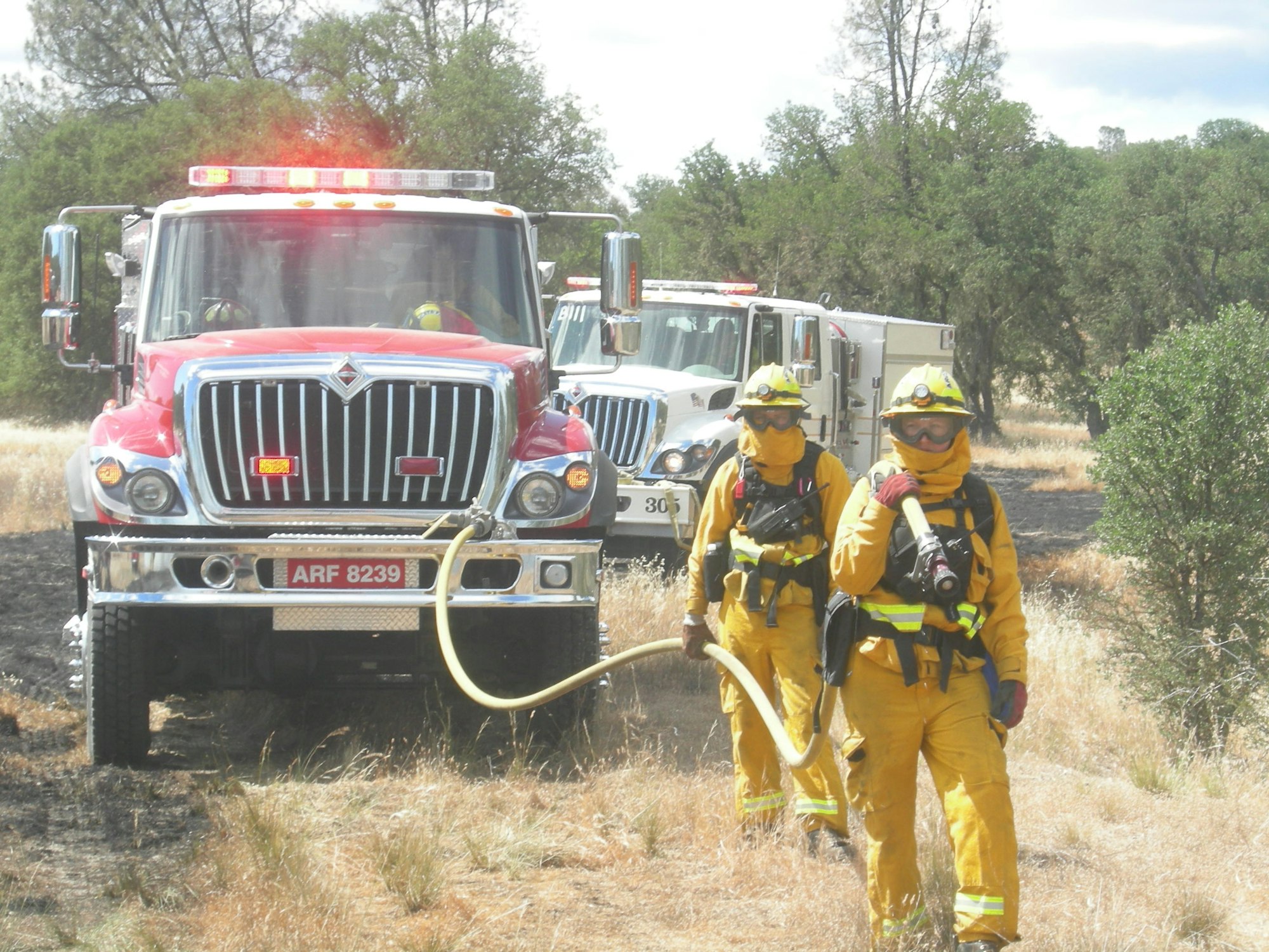 Firefighters performing pump and roll on a training burn at Fort Hunter Ligget.