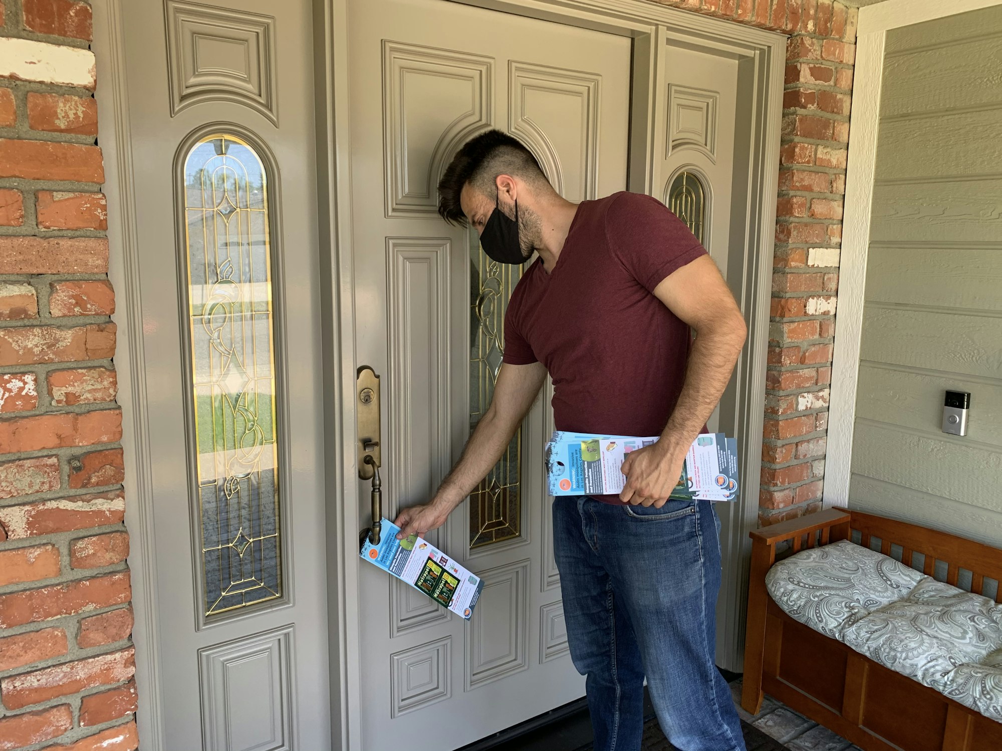 A man distributing door hangers