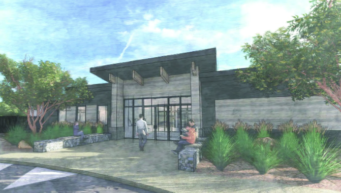 Modern building with glass entrance, surrounded by trees and shrubs. People sitting and walking outside.