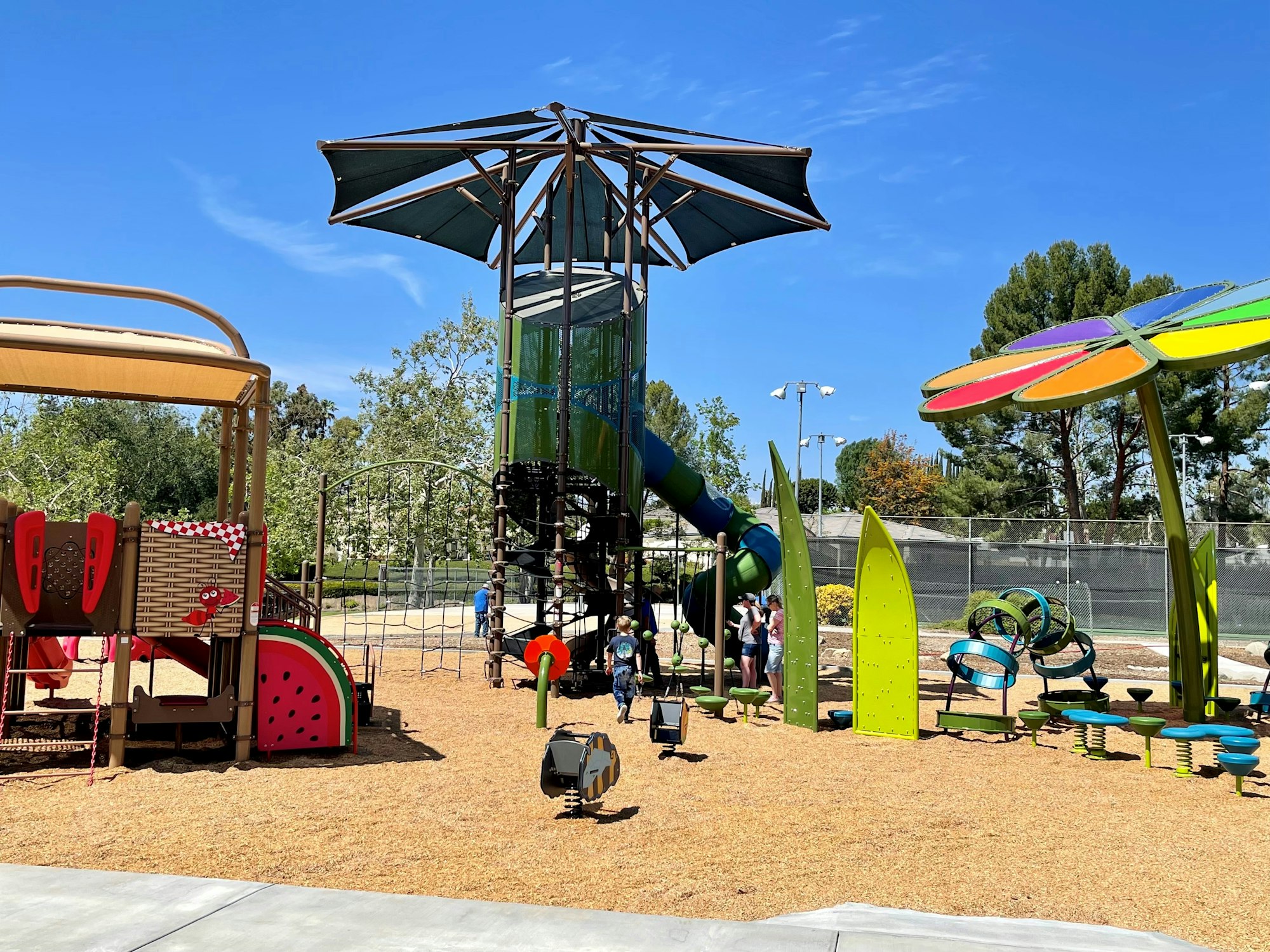 May contain: outdoor play area, outdoors, play area, person, accessories, bag, handbag, clothing, footwear, and shoe