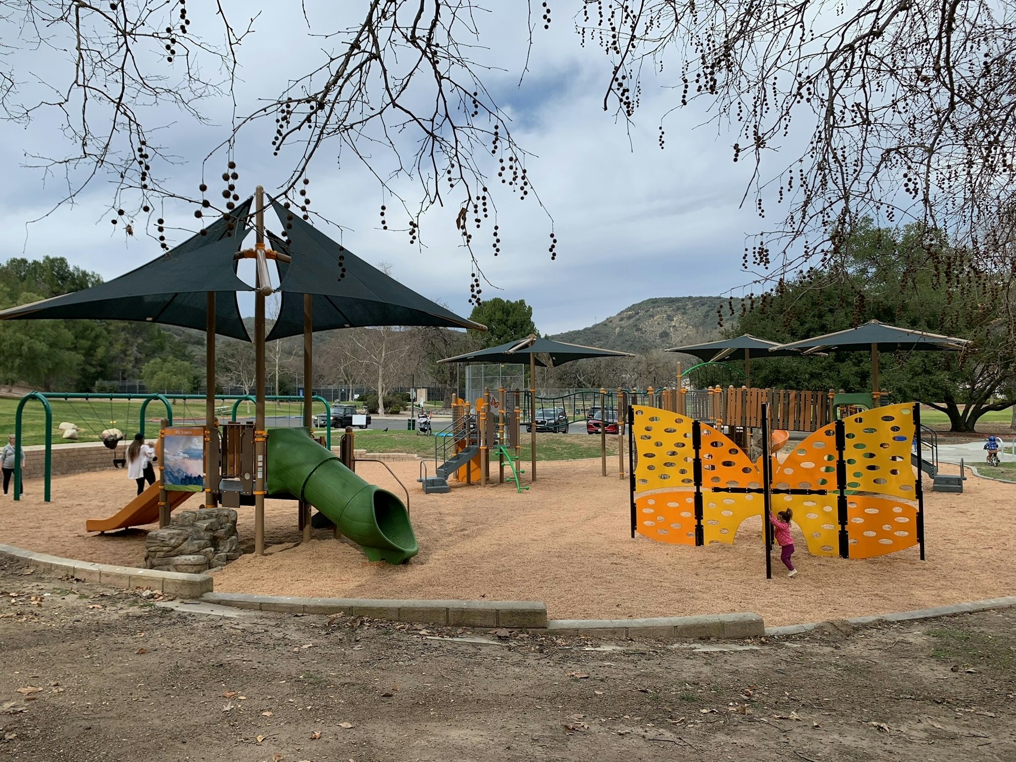 May contain: outdoor play area, outdoors, play area, person, clothing, footwear, shoe, car, transportation, and vehicle