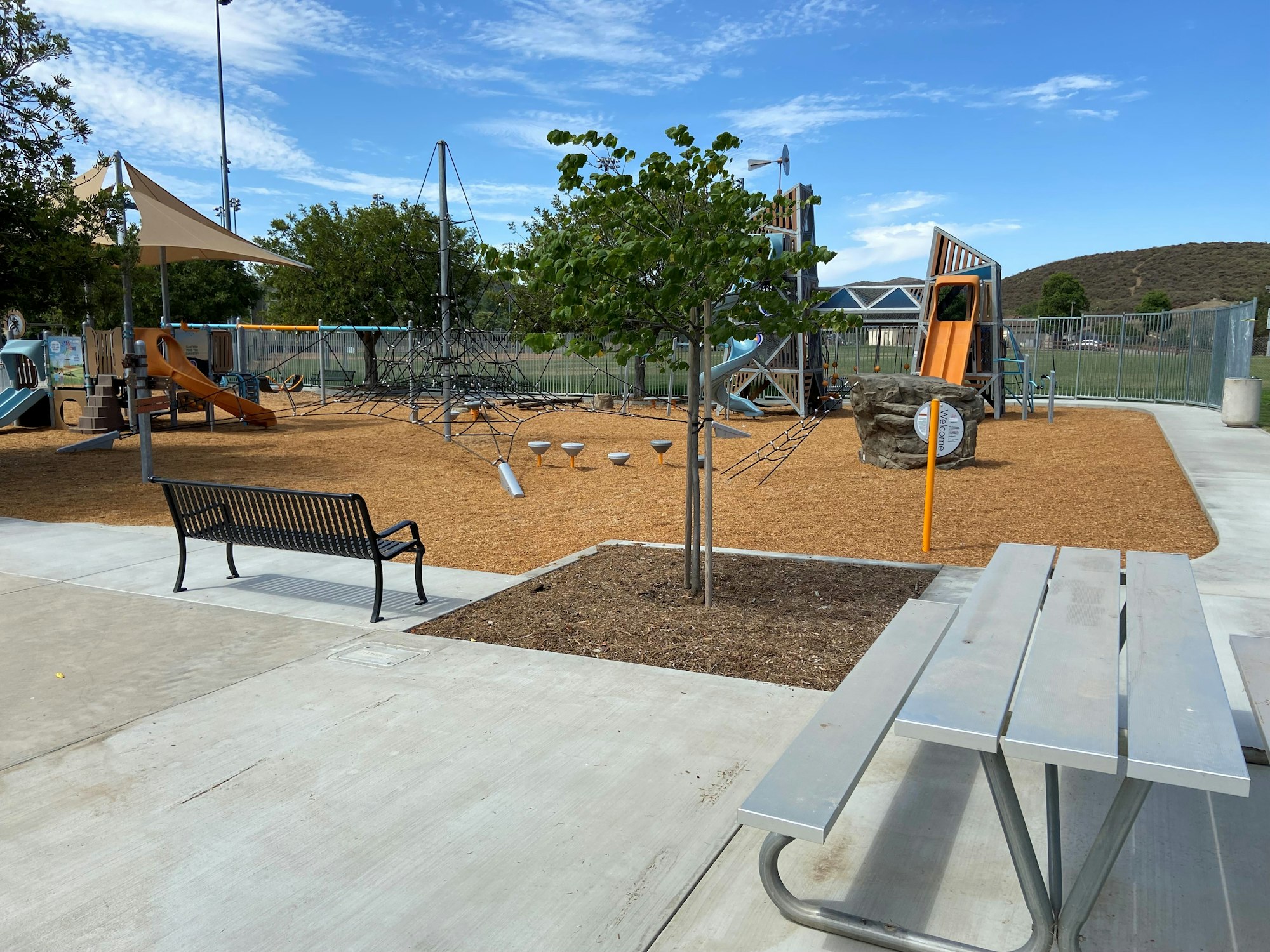 May contain: outdoor play area, outdoors, play area, grass, nature, park, plant, bench, and furniture
