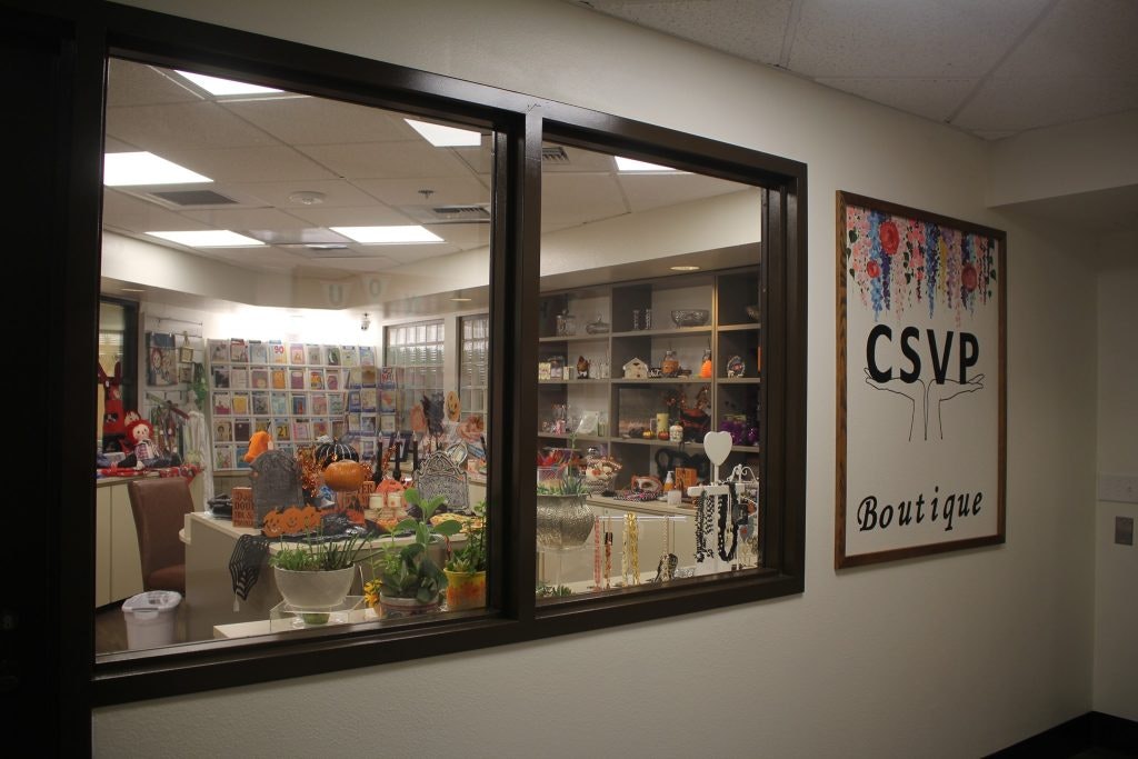 A boutique with various items displayed, like decorations and accessories. A sign reads "CSVP Boutique."