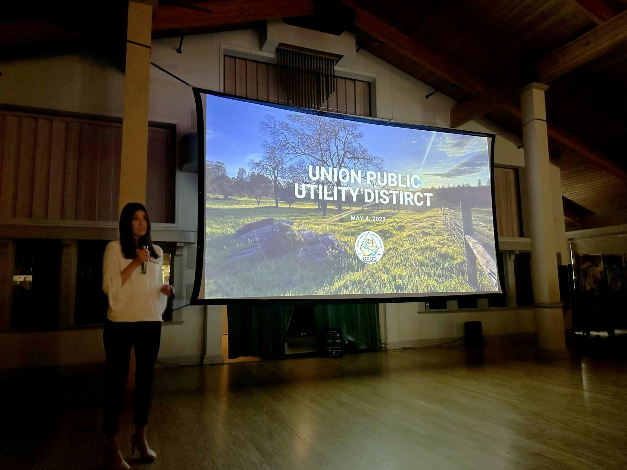 A person presenting in front of a screen displaying "Union Public Utility District" and "May 4, 2023" with a nature background.