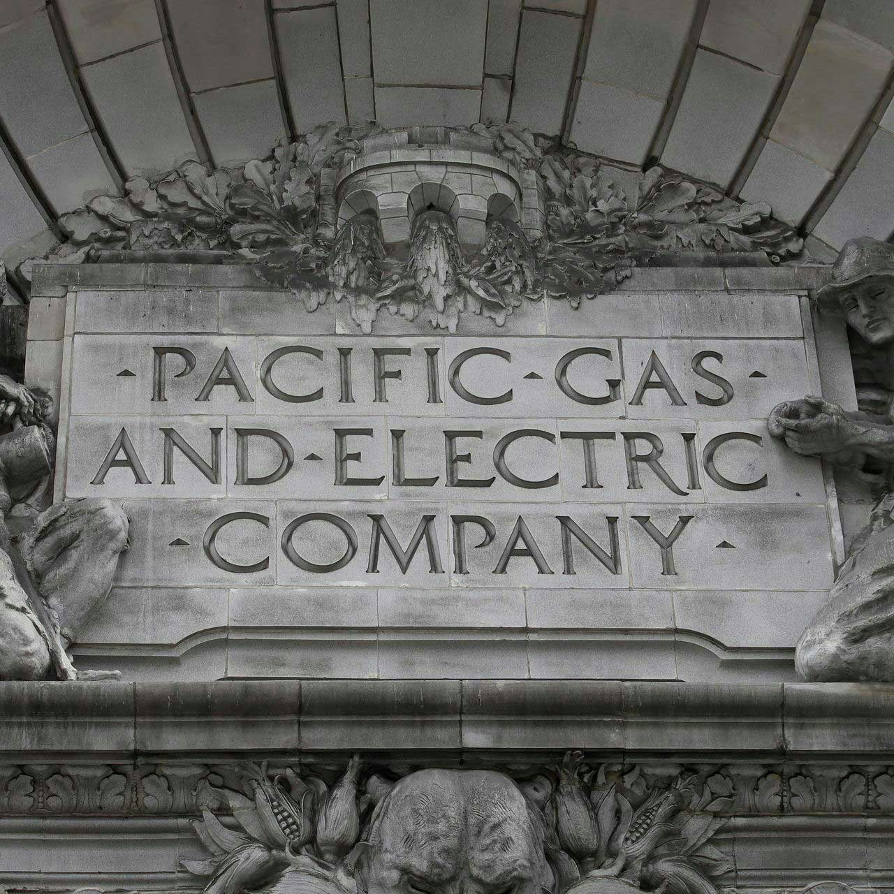 Stone sign reading "Pacific Gas and Electric Company" with decorative sculptures.