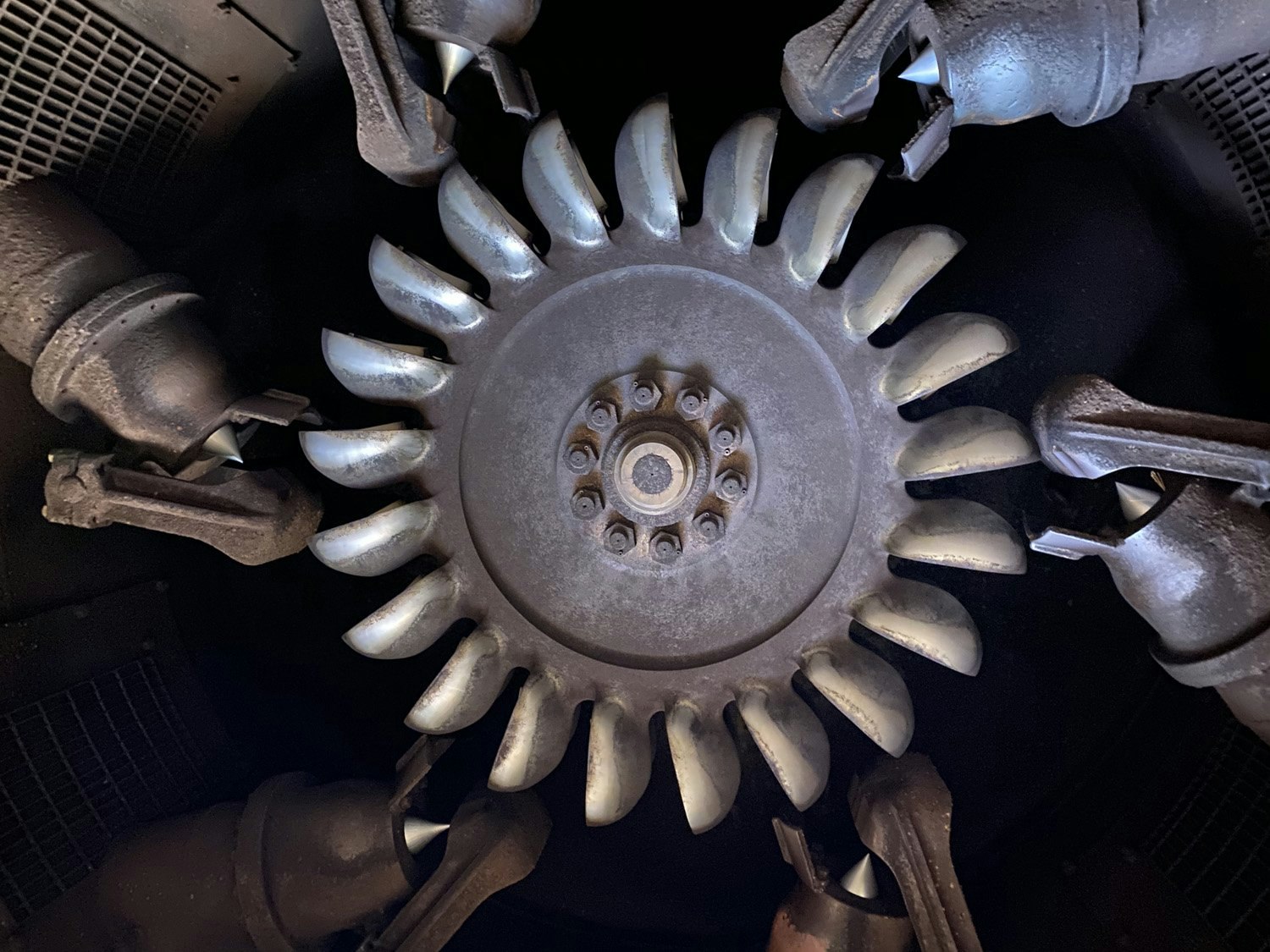 A close-up of a mechanical turbine or rotor with multiple blades and surrounding components.