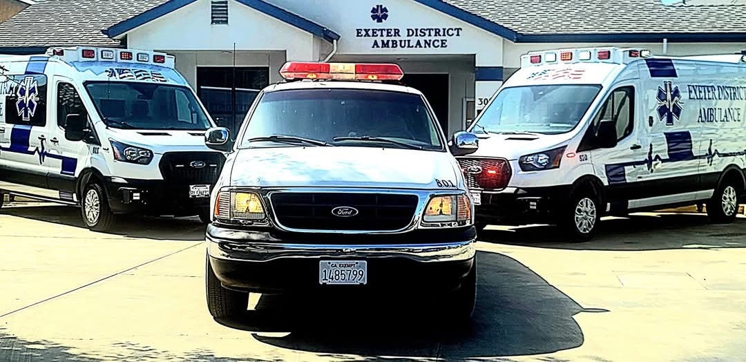 Three ambulances parked in front of Exeter District Ambulance building.