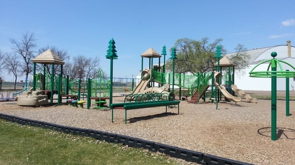 May contain: outdoor play area, outdoors, play area, bench, furniture, grass, nature, park, and plant