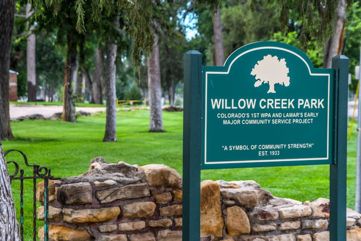 Sign for Willow Creek Park, highlighting its historic community service project significance. Established in 1933.