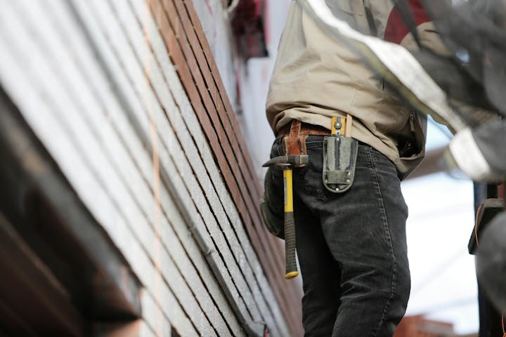 Person working with tools on a construction site.