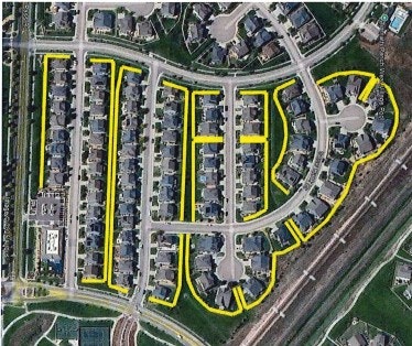 The image shows an aerial view of a residential neighborhood with highlighted roads and houses.
