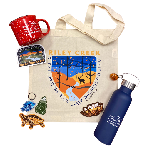 Merchandise with "Riley Creek" logos: tote bag, enamel pins, patch, water bottle, mug, and a button.