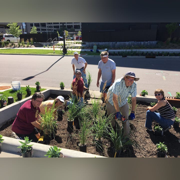 Group of people gardening together in an urban environment.