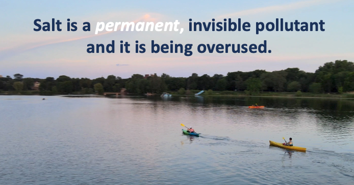 Two kayakers on a lake with a message about salt pollution.
