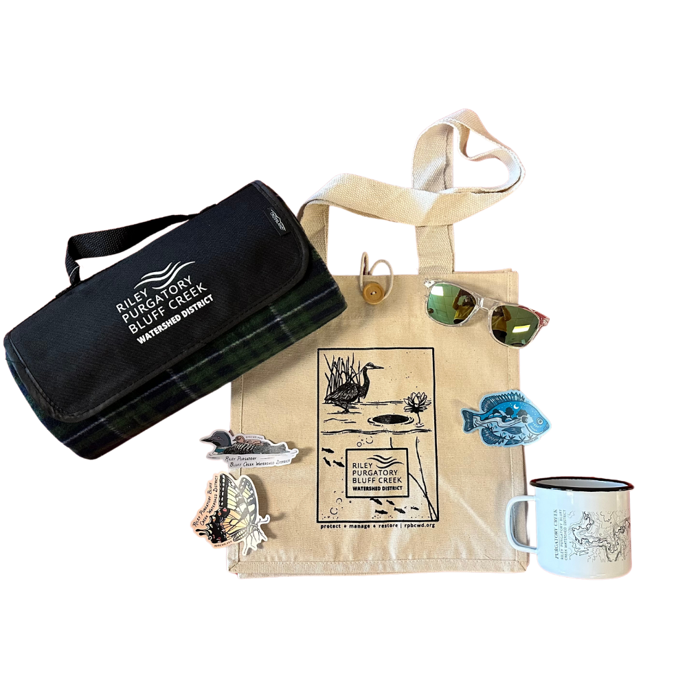 Tote bag with printed design, foldable blanket, sunglasses, stickers, and a mug.