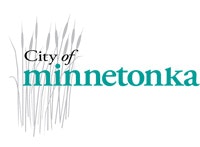 A logo with the text "City of Minnetonka" and a graphic representation of reeds or grasses.