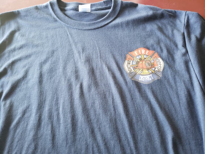 Navy blue tee shirt with Tightwad Fire Protection District red, white, and blue logo