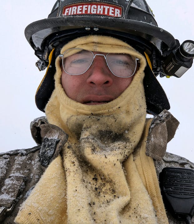 Firefighter in helmet and cloth hood