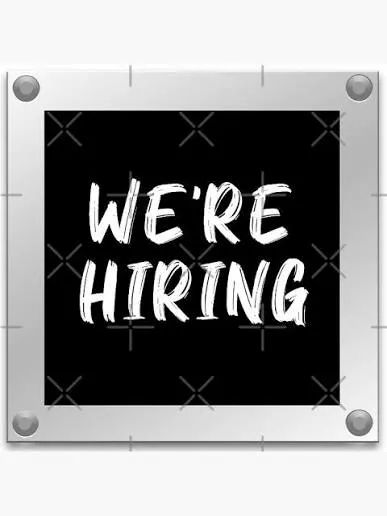 A sign that says "WE'RE HIRING" on a black background with a metallic border.