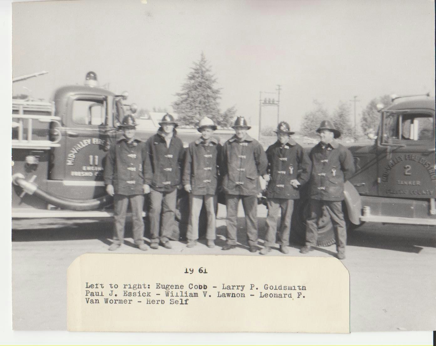 black and white picture of the 6 person crew in front of the two engines standing in full safety uniform