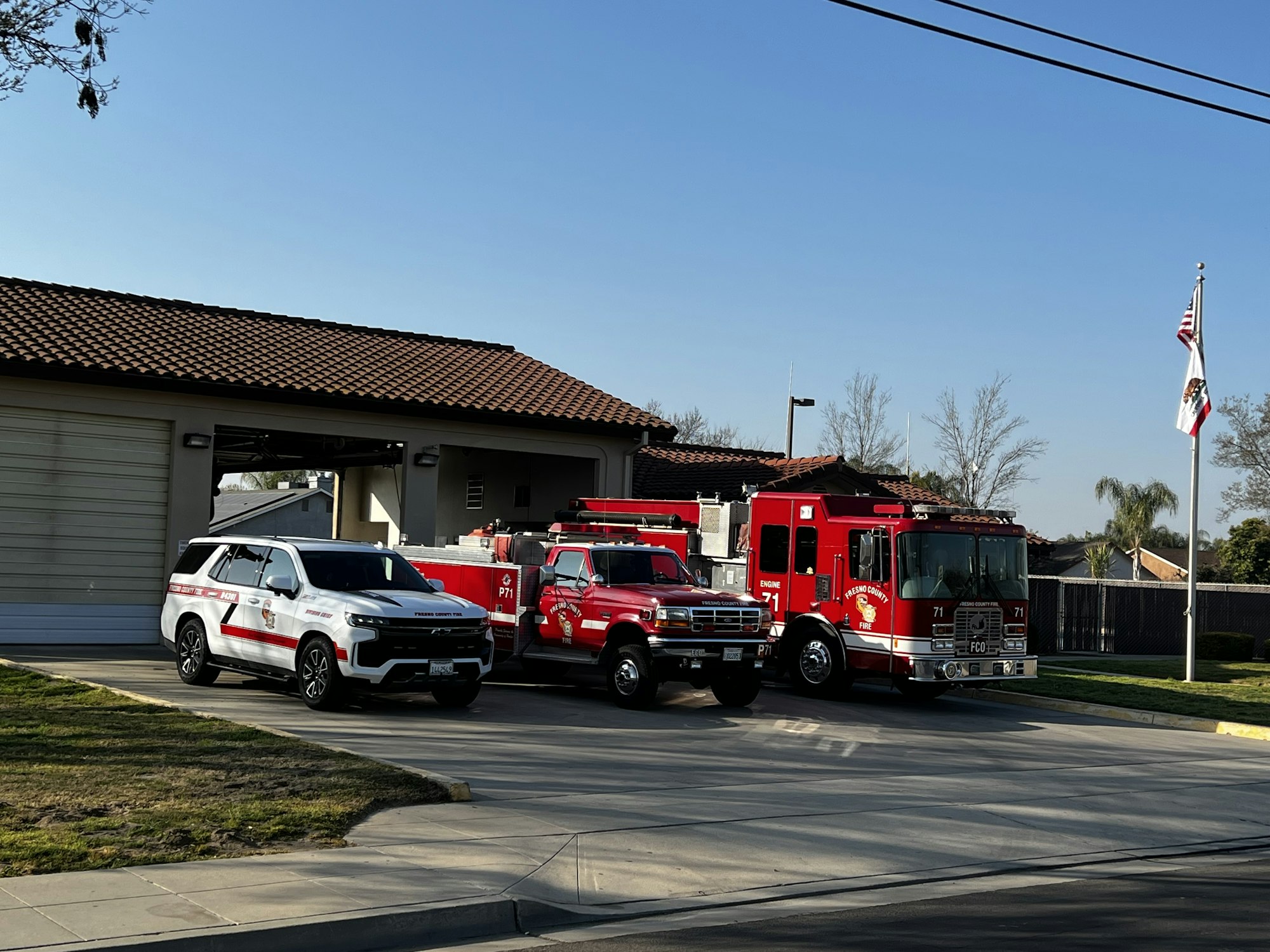 Fresno County Fire Station 90 in Parlier with a Fire Engine and Patrol and Chief Truck in front of facility