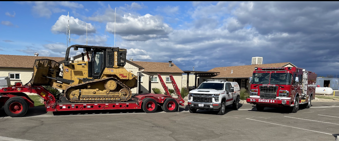 Engine 84, Battalion chief 4318, and transport dozer stagged in front of the barrack at headquarters