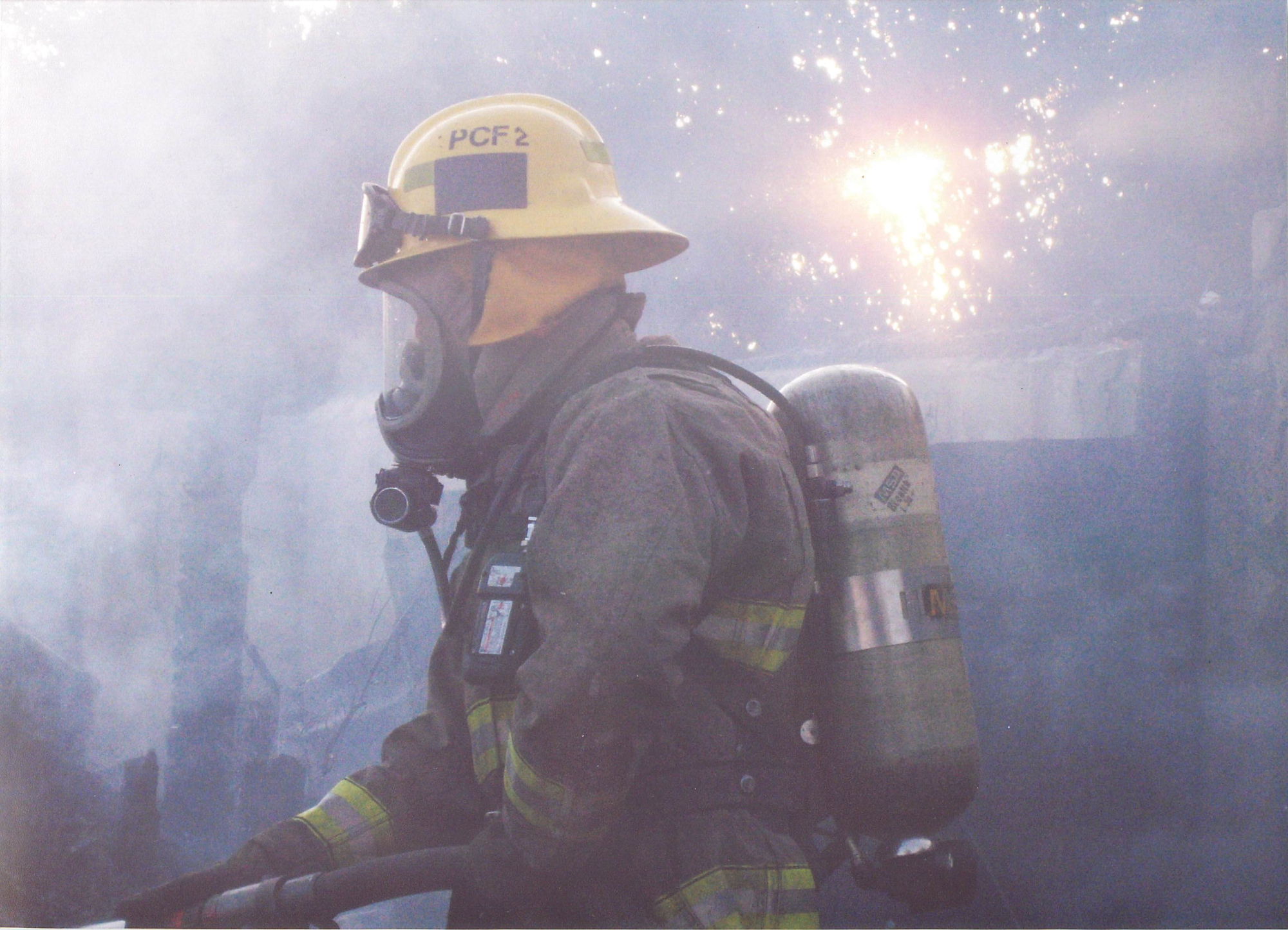 fireman with helmet and hose