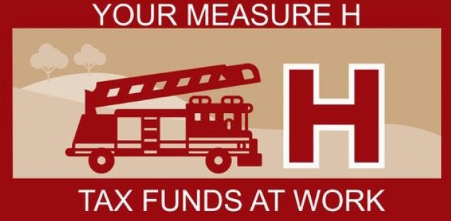 Red sign with a fire truck illustration and the text "YOUR MEASURE H TAX FUNDS AT WORK."