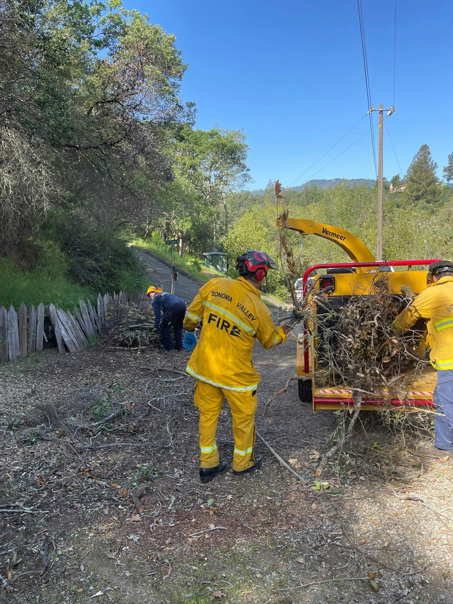 firefighter operating brush / tree chipper