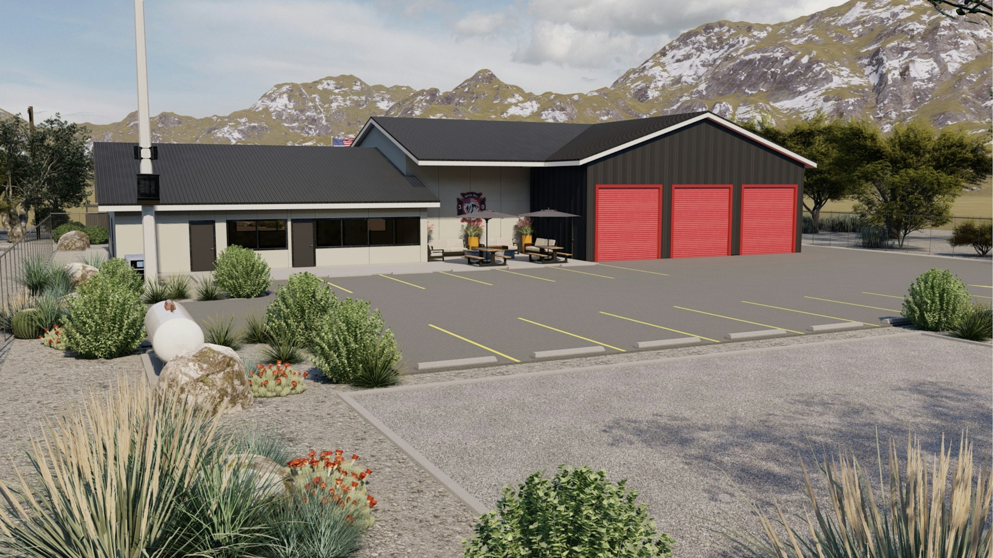 A building with gray roof, red garage doors, parking spaces, and landscaping, set against a mountain backdrop.
