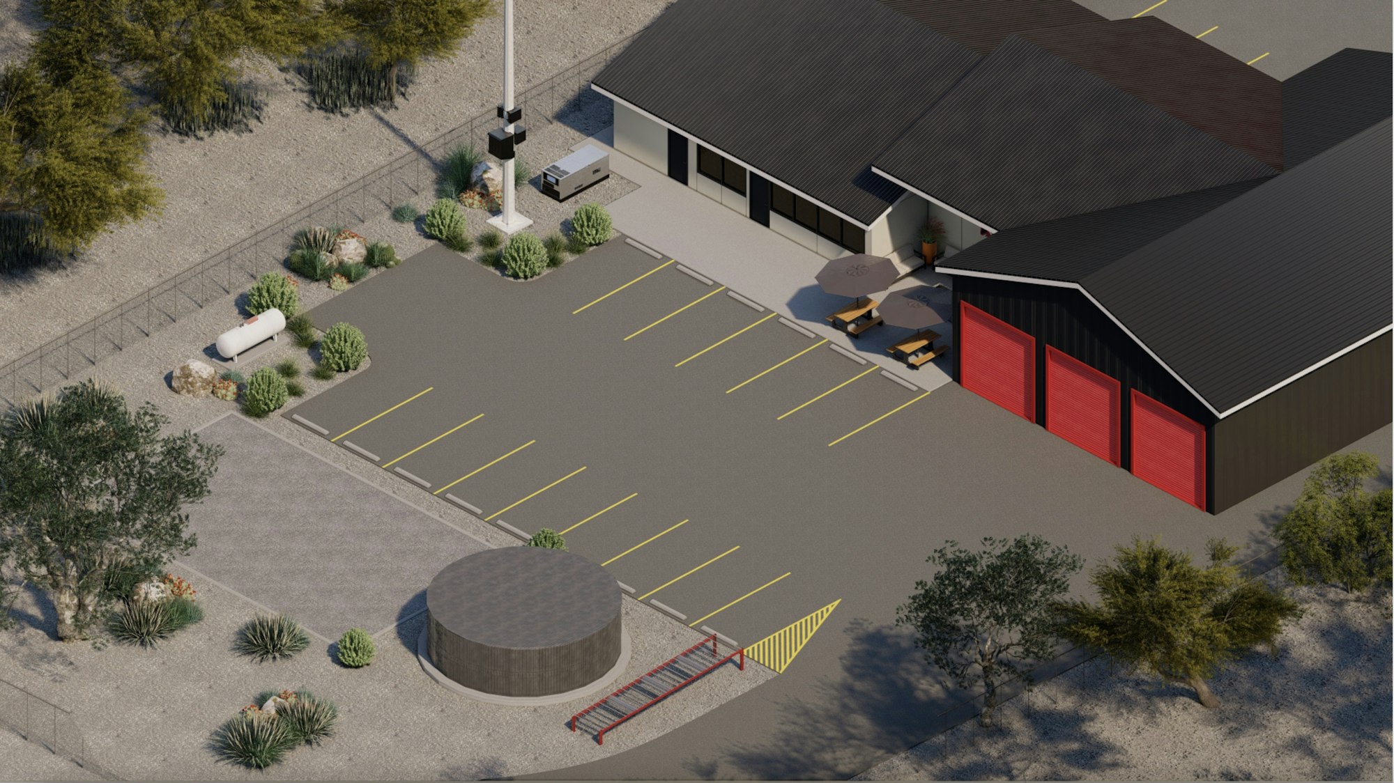 Aerial view of a parking lot with yellow lines, a building with red doors, picnic tables, and surrounding trees and shrubs.