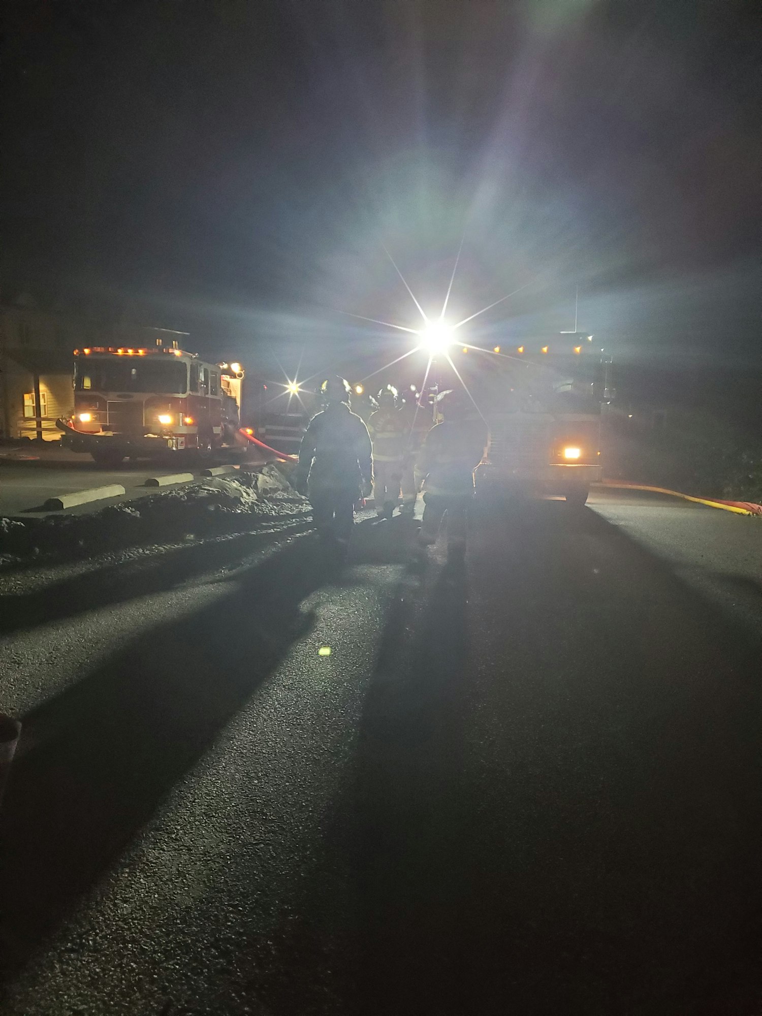 May contain: flare, light, tarmac, asphalt, road, person, and human