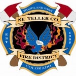 The image features the NE Teller County Fire District emblem from Woodland Park, Colorado, established in 1985, with fire imagery.