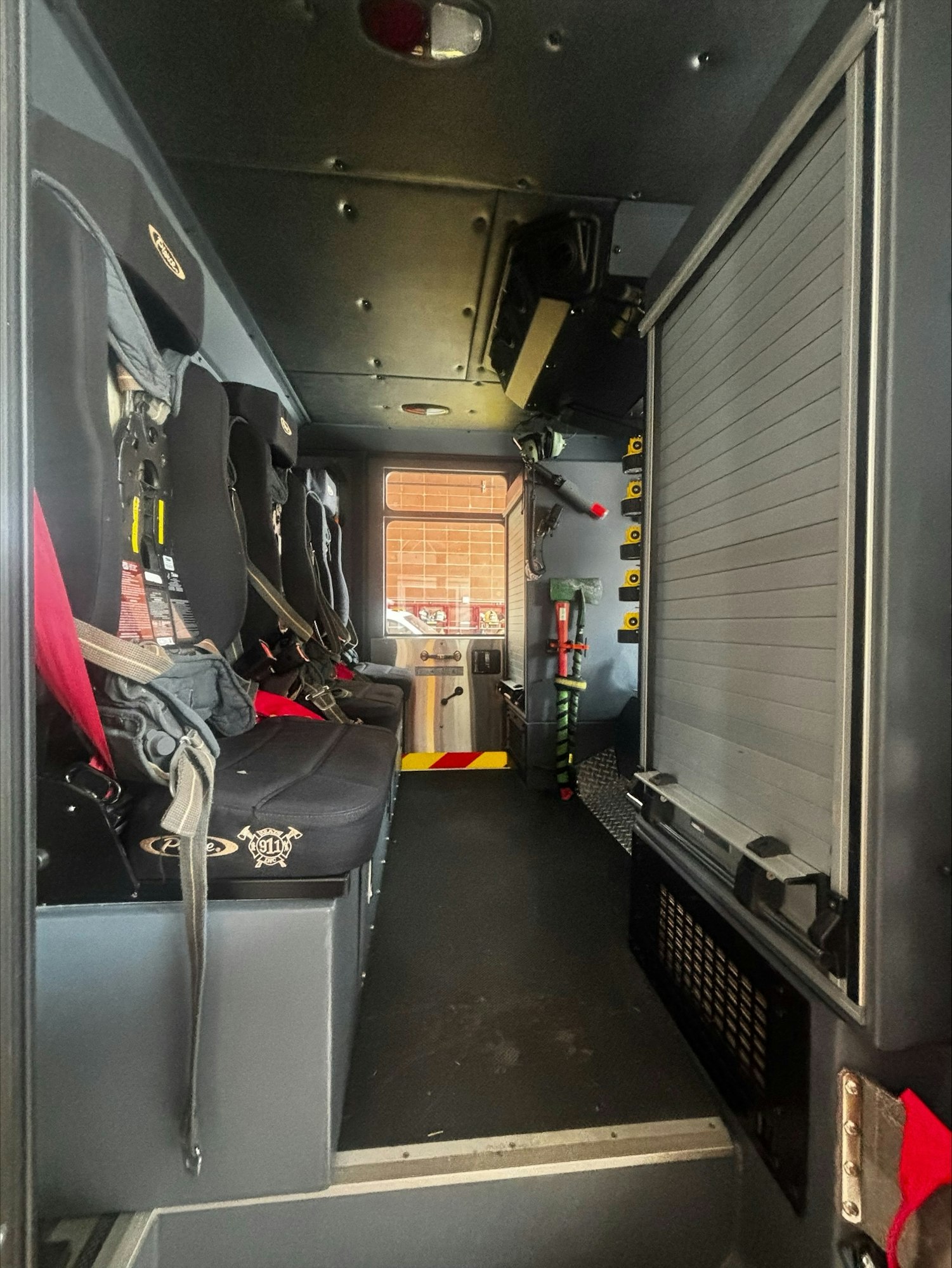 The image shows the interior of a vehicle with rows of seating and equipment, likely used for emergency or rescue operations.