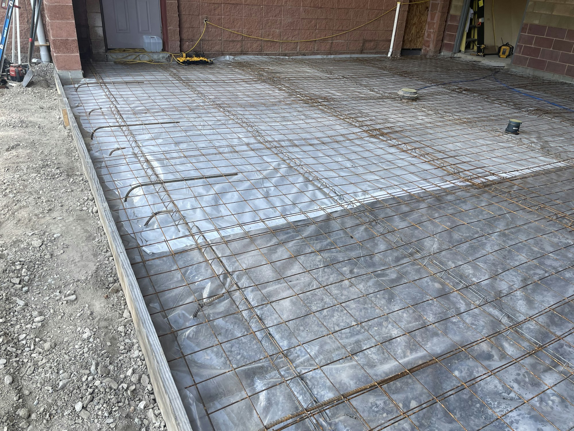 Preparing a concrete foundation with steel reinforcement grid.