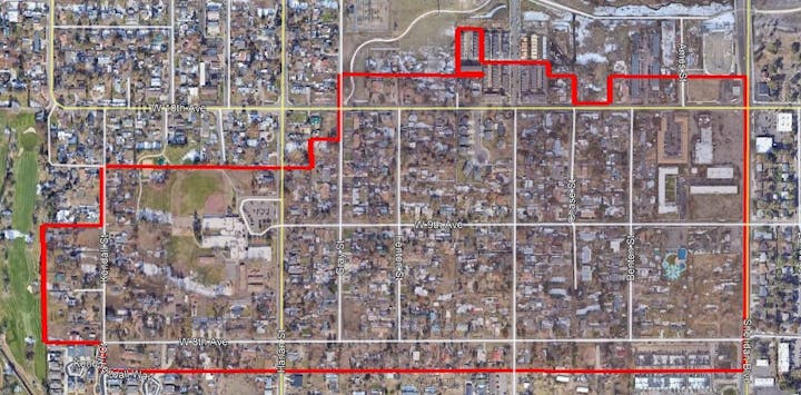 District boundary map- An aerial view of a residential area with streets, houses, and a marked boundary in red.