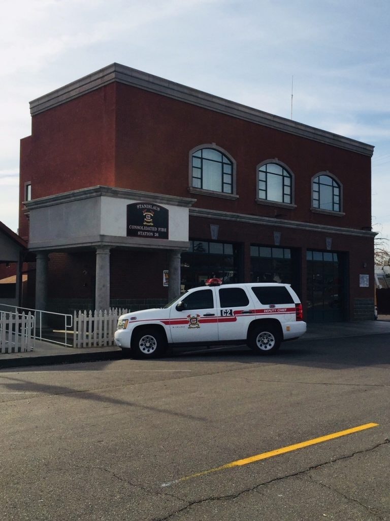 A fire station with a deputy chief's SUV parked outside.