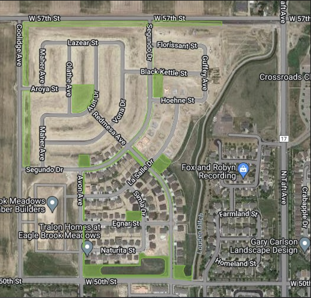 A satellite map of a residential area with labeled streets and homes, featuring green spaces and some under-construction areas.
