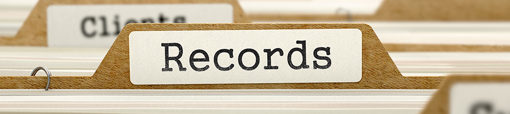 Close-up of a "Records" tab on a file in a filing cabinet.