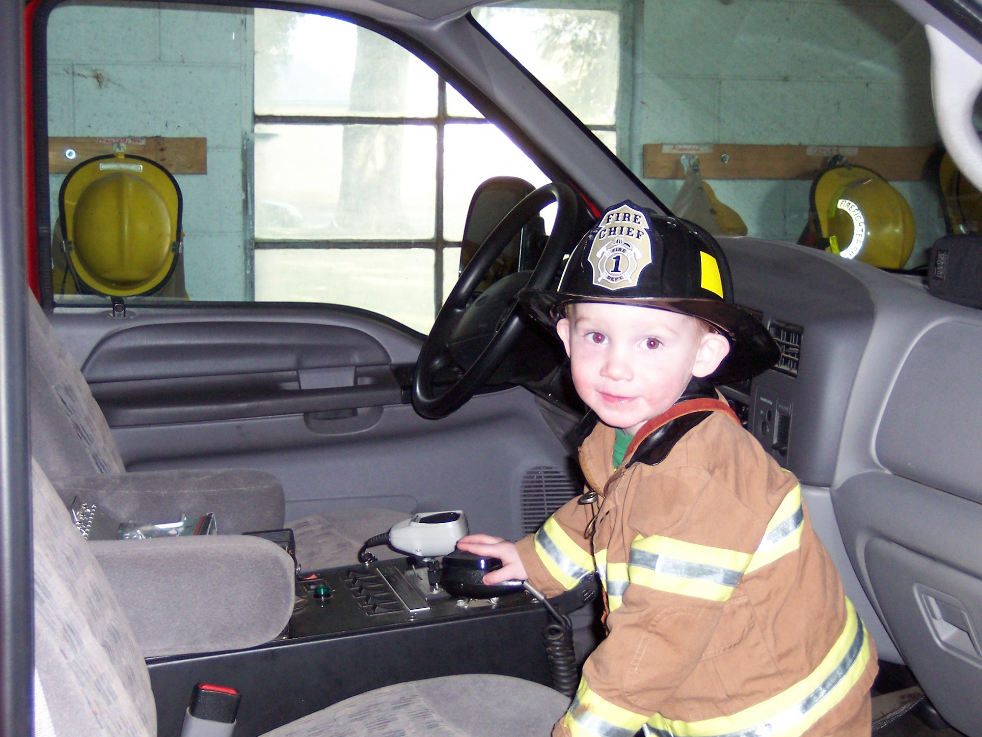May contain: person, human, helmet, clothing, apparel, car, transportation, vehicle, automobile, and fireman