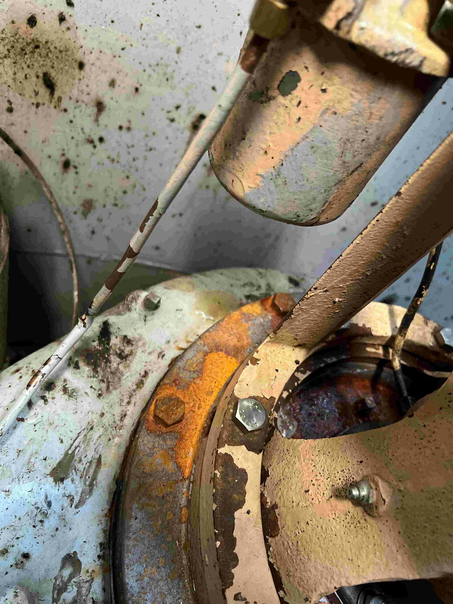Rusty and worn mechanical parts, possibly from machinery or automotive equipment.