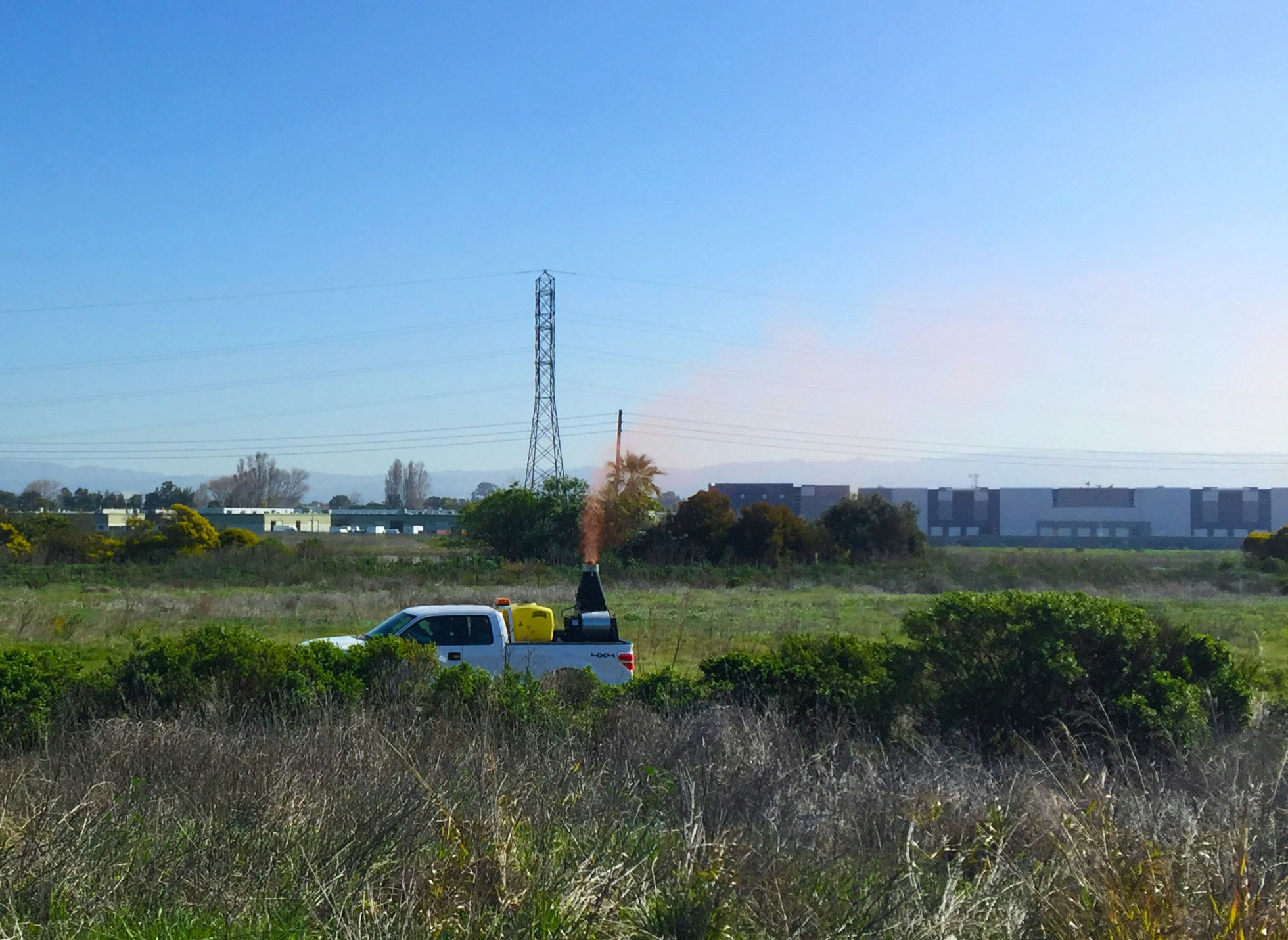 field with truck spraying