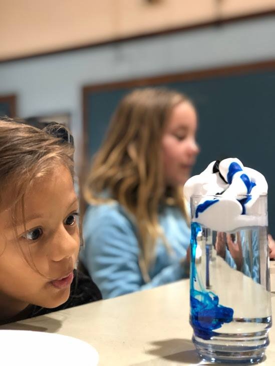 Student watching a water and shaving cream experiment