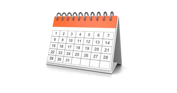 The image shows a tabletop calendar with days numbered from 1 to 31, featuring a spiral binding and an orange header.