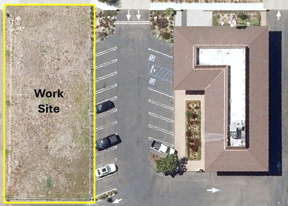 An aerial view showing a parking lot, a building shaped like an L, and a labeled work site area to the left.