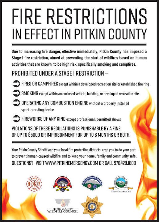 A fire restriction notice for Pitkin County outlining banned activities like campfires and fireworks, mentioning fines and imprisonment penalties.