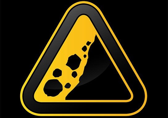 A triangle-shaped sign with a cheese illustration, depicting a "cheesy" concept of a hazard warning sign.