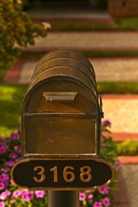 A mailbox with the number 3168, surrounded by flowers.